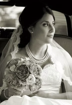 Bride sitting in black limo