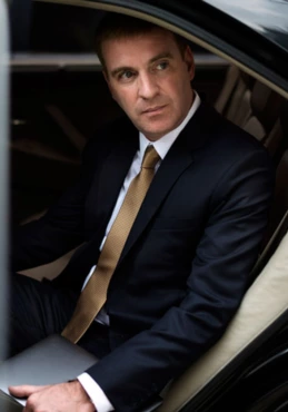 A business man sitting in a luxury car